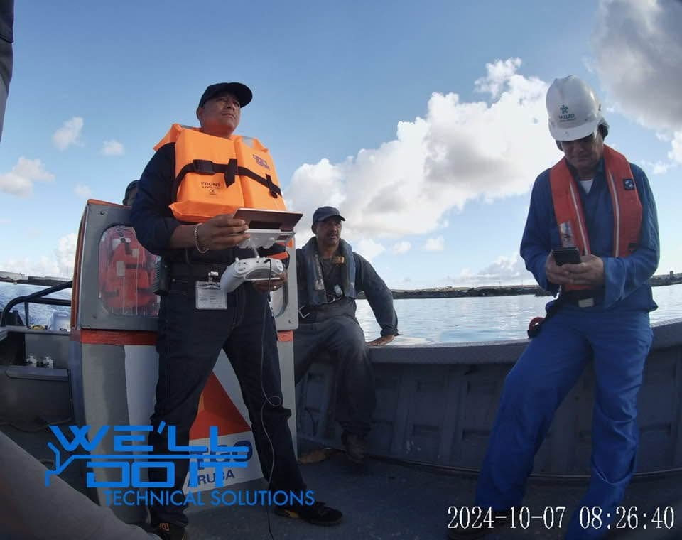 People operating drone equipment from a boat